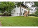 A rear view of the house featuring a backyard with a covered deck and stairs, perfect for outdoor entertaining at 754 Fayetteville Se Rd, Atlanta, GA 30316