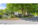 Neighborhood street with a community mailbox and lush green trees lining the street at 121 Dunleith Sw Pkwy, Marietta, GA 30008