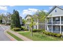 Residential street featuring well-maintained two-story homes with covered front porches at 121 Dunleith Sw Pkwy, Marietta, GA 30008