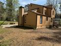 A spacious backyard with a home featuring neutral siding and a covered patio at 2915 Creek Park Dr, Marietta, GA 30062