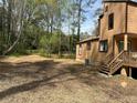 A mulched backyard area leading to a home with a deck and wooded surroundings at 2915 Creek Park Dr, Marietta, GA 30062