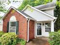 Close up of brick and vinyl exterior featuring a window and front door at 645 Crossbridge Aly, Johns Creek, GA 30022