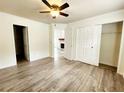 Bright main bedroom featuring wood floors, ensuite access, and closet at 645 Crossbridge Aly, Johns Creek, GA 30022