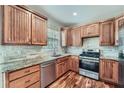 Well-lit kitchen showcasing wooden cabinets, granite countertops, stainless steel appliances, and elegant hardwood floors at 3765 Clear Lake Nw Way, Acworth, GA 30101