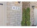 Close-up of the house number 8335 on a brick facade with exterior lighting at 8335 Village Pl, Suwanee, GA 30024