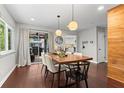 Dining room features hardwood floors, stylish lighting, and sliding door access to an outdoor area at 3085 Balearic Se Dr, Marietta, GA 30067
