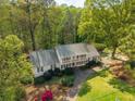 Beautifully landscaped two-story home with manicured lawns and a private driveway, nestled among mature trees at 1800 East Gate Dr, Smoke Rise, GA 30087