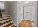 Bright entryway featuring hardwood floors, a staircase, and an ornate front door with sidelights at 4819 Elam Rd, Stone Mountain, GA 30083