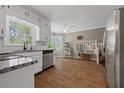Modern kitchen with stainless steel appliances, granite countertops, and wood-look tile flooring at 4819 Elam Rd, Stone Mountain, GA 30083
