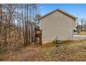 View of the home's siding with a balcony and outdoor stairway at 510 Ashland Manor Dr, Lawrenceville, GA 30045