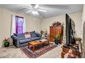 Cozy living room with a plush sofa, patterned rug, and entertainment center at 510 Ashland Manor Dr, Lawrenceville, GA 30045
