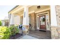Inviting front porch with stone accents and a welcoming wreath on the front door at 715 Laura Jean Court, Buford, GA 30518