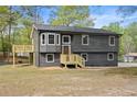 Charming home featuring a gray exterior, complemented by a spacious deck, perfect for outdoor entertaining at 7244 Valley Dr, Winston, GA 30187