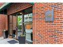 Building entrance showcasing the Centennial House plaque and brick facade at 115 W Peachtree Nw Pl # 304, Atlanta, GA 30313