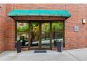 Exterior shot of building entrance featuring a canopy and glass doors at 115 W Peachtree Nw Pl # 304, Atlanta, GA 30313