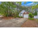 Charming home with a one car garage, long driveway and manicured landscape in the front at 1164 Britley Park Ln, Woodstock, GA 30189