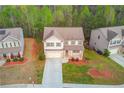 An aerial view of the home and manicured lawn in a residential neighborhood at 2045 Villa Spring Ct, Dacula, GA 30019