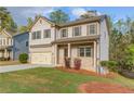 Charming two-story home in a well-kept community with a manicured lawn at 2045 Villa Spring Ct, Dacula, GA 30019