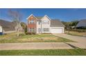 Beautiful two-story home with a well-kept lawn, a two-car garage, and a welcoming entrance at 2470 Cordillo Dr, Dacula, GA 30019
