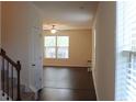 Inviting living room with large windows and a ceiling fan providing ample light at 4265 Almanor Cir, Norcross, GA 30071