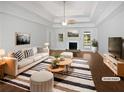 Bright, neutral living room with fireplace, ample seating, and modern decor at 2021 Emerald Dr, Loganville, GA 30052