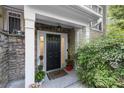 Charming front door with stone accents and manicured landscaping, creating an inviting entrance to the home at 2400 Cumberland Se Pkwy # 804, Atlanta, GA 30339