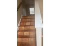 Stairs leading to upper level with decorative tile and a window providing natural light at 4423 Roche St, Atlanta, GA 30349