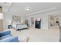 Bright main bedroom with tray ceiling, neutral carpet, and an ensuite bathroom at 7200 Brigidoon Rose, Douglasville, GA 30134