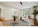 Inviting living room with hardwood floors, comfortable seating, and views into other living spaces at 78 Beverly Ne Rd, Atlanta, GA 30309