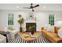 Cozy living room featuring a fireplace, hardwood floors, and ample seating with natural light at 78 Beverly Ne Rd, Atlanta, GA 30309