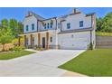 Charming two-story home with a two-car garage, manicured lawn, and inviting front porch at 399 Tillman Pass, Woodstock, GA 30188