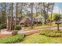 Beautifully landscaped front yard of home showcasing mature trees and meticulous lawn care at 883 Wildwood Ne Rd, Atlanta, GA 30324