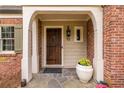Inviting front entrance with stone flooring, brick facade, and wooden door detail at 883 Wildwood Ne Rd, Atlanta, GA 30324