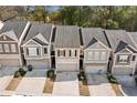 An aerial view showing the townhome community, featuring a row of well-maintained homes with private driveways at 3016 Creekside Overlook Way, Austell, GA 30168