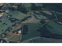 Overhead view of a sprawling property, highlighting the home's secluded location with expansive surrounding acreage outlined in yellow at 85 Carroll Slough Rd, Kingston, GA 30145