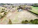 Expansive aerial view showcases a charming home surrounded by a lush landscape, offering privacy and serene country living at 85 Carroll Slough Rd, Kingston, GA 30145