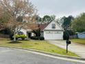 Charming single-story home featuring a two-car garage and a well-manicured front yard with mature landscaping at 2520 Legend Mill Run, Dacula, GA 30019