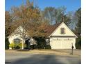 Charming single-story home featuring a two-car garage and a well-manicured front yard with mature landscaping at 2520 Legend Mill Run, Dacula, GA 30019
