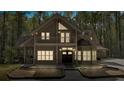 Charming two-story home with a balcony, covered porch, mature trees, and exterior lighting at 3800 Macland Rd, Hiram, GA 30141