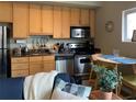 A well-appointed kitchen with stainless steel appliances and granite countertops, adjacent to a cozy dining area at 620 Glen Iris Ne Dr # 401, Atlanta, GA 30308