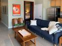 A modern living room with a comfortable couch, movie poster, and a peek into the bedroom through an open doorway at 620 Glen Iris Ne Dr # 401, Atlanta, GA 30308
