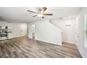Open-concept living area with wood-look floors and a ceiling fan at 4437 Ben Hill Rd, Atlanta, GA 30349