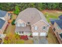 Stunning aerial view of a brick two-story home with lush greenery and a private backyard at 1633 Park Hollow Ln, Lawrenceville, GA 30043
