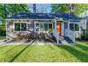 Attractive exterior with a gray facade, red roses, and an eye-catching orange front door at 22 Vinson Se Dr, Atlanta, GA 30317