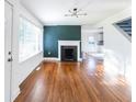 Sun-filled living room boasts gleaming hardwood floors and a stylish fireplace with black tile at 22 Vinson Se Dr, Atlanta, GA 30317