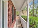 Inviting front porch with white columns and lush landscaping providing curb appeal at 404 Foxwood Ct, Mcdonough, GA 30253