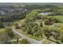 Expansive aerial view of property showcasing its wooded lot and neighborhood surroundings at 5125 Dahlonega Hwy, Cumming, GA 30028