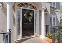 Charming front door with decorative wreath, framed by columns and lush greenery at 5334 Lake View Clb, Atlanta, GA 30338