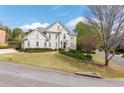 View of home showing manicured lawn and tidy landscaping with mature shade tree at 5334 Lake View Clb, Atlanta, GA 30338