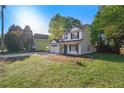 Charming two-story home with white siding, black shutters, and a large front yard at 3527 Clare Cottage Sw Trce, Marietta, GA 30008